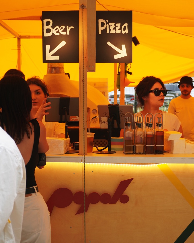 Popolo pop-up counter serving beer and pizza at an event