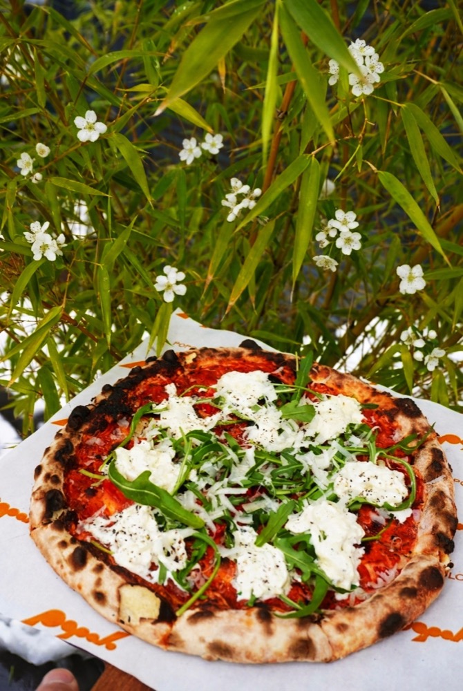 Stracciatella dish served with a spoon at the table