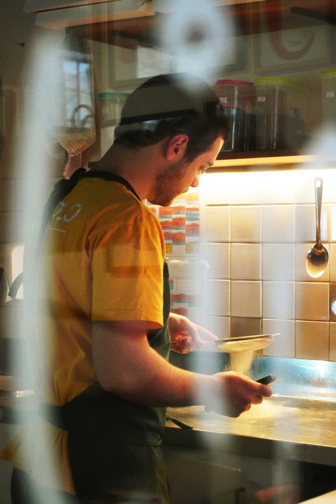 A cook working at the prep counter