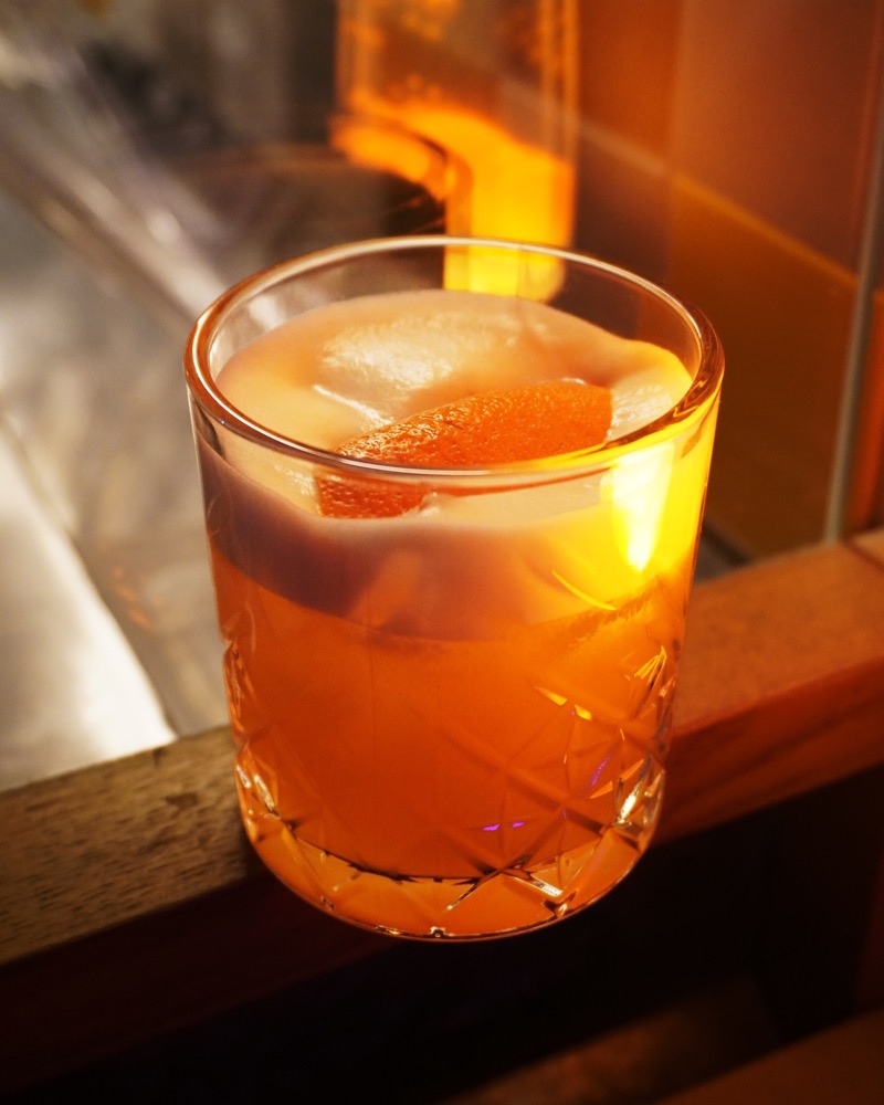 A cocktail glowing on the window ledge